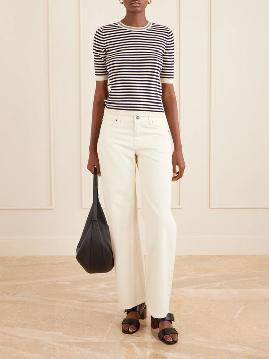 Image of a model wearing Tops. Product name - Striped Cotton-blend T-shirt in Black colour by brand - FRAME