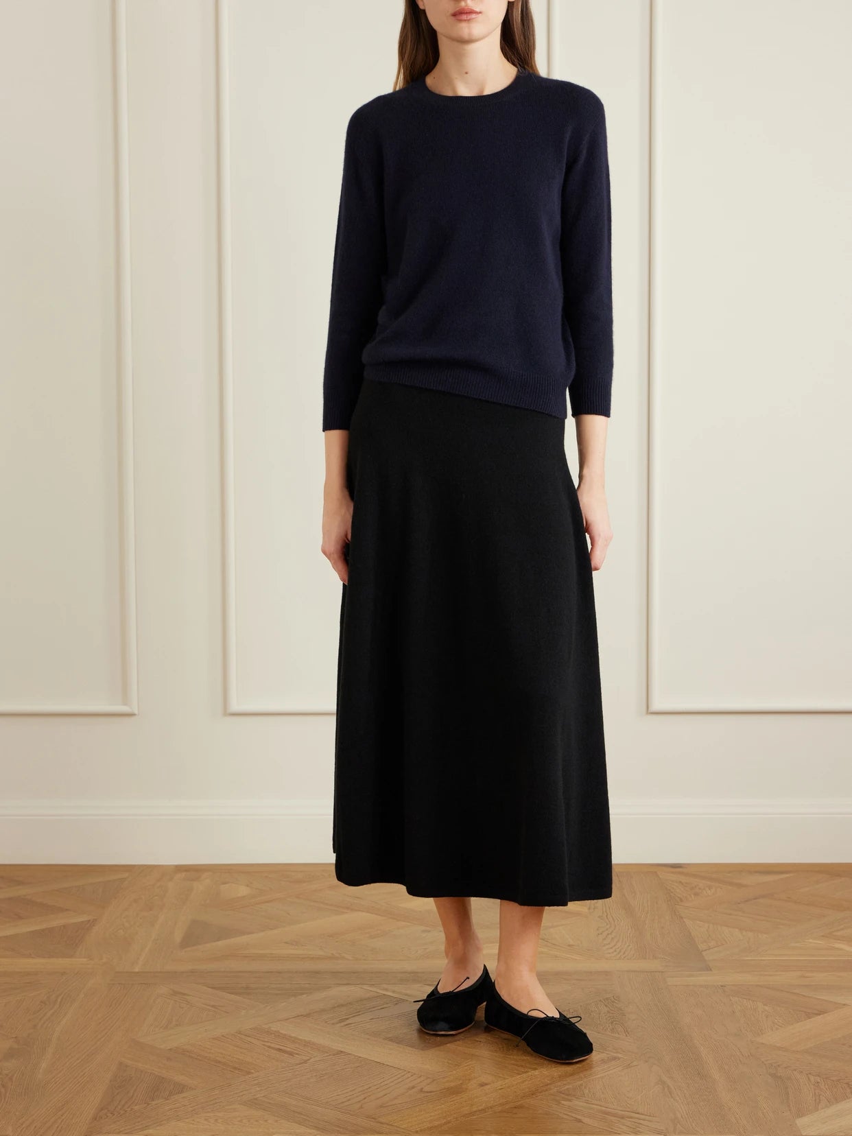 Image of a model wearing Skirts. Product name - Masini Cashmere-blend Midi Skirt in Black colour by brand - The Row