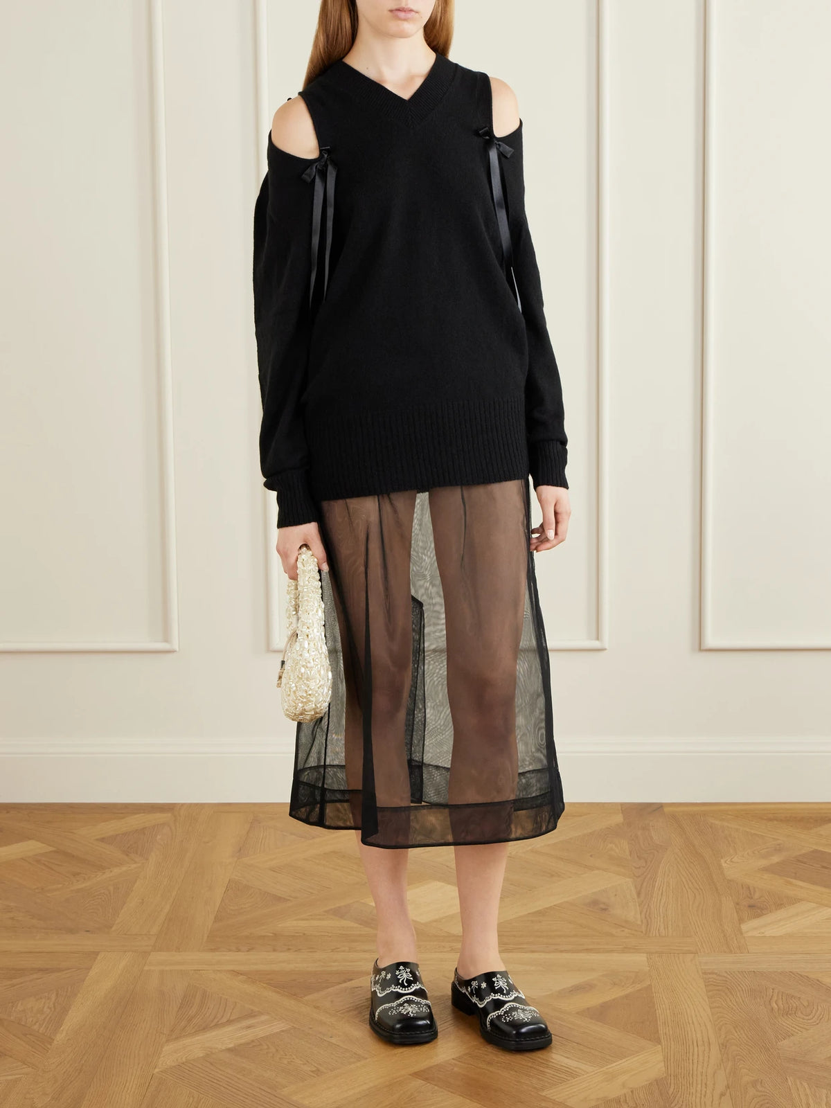 Image of a model wearing Skirts. Product name - Organza Midi Skirt in Black colour by brand - Simone Rocha