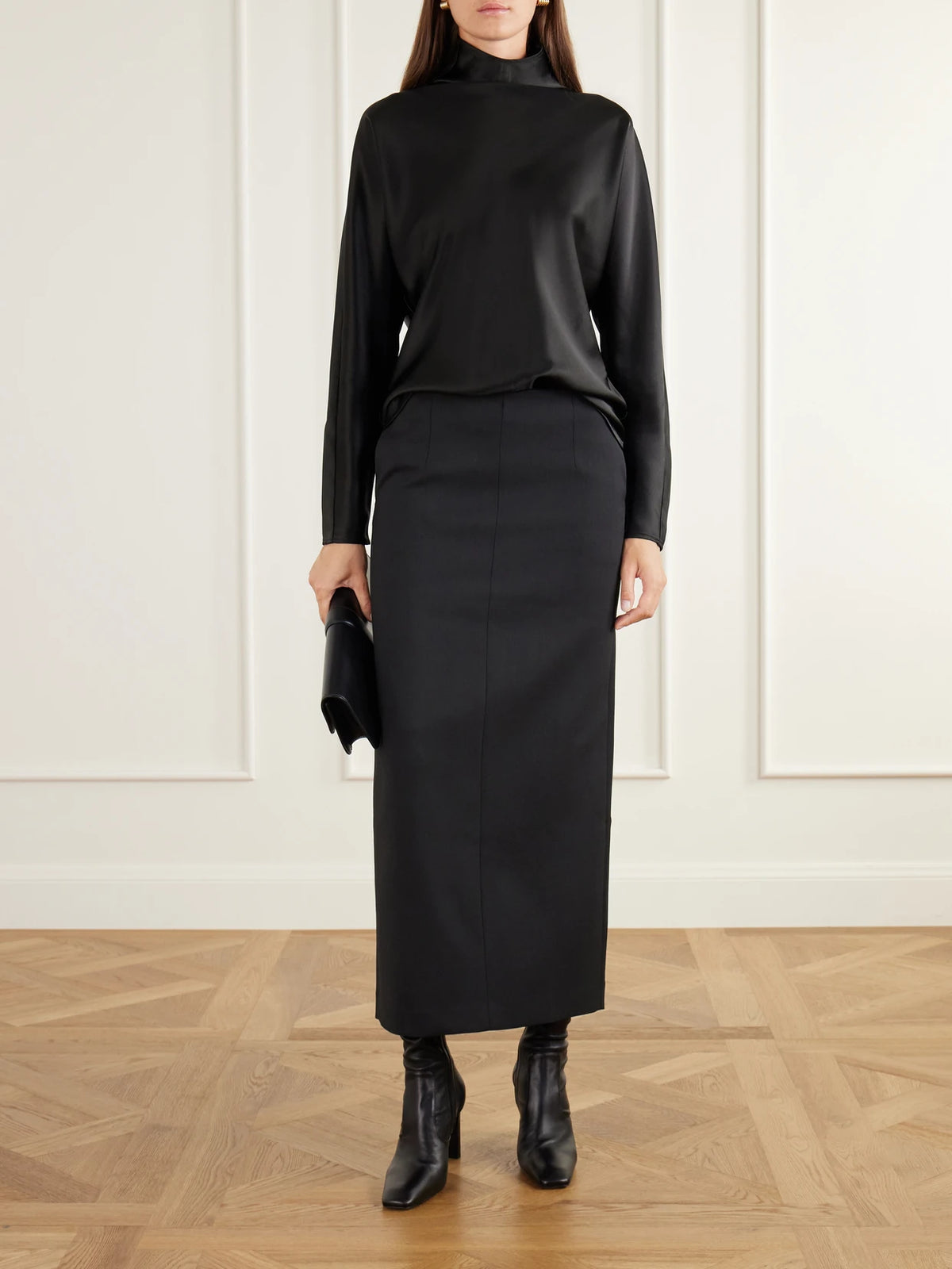 Image of a model wearing Skirts. Product name - Bay Twill Midi Skirt in Black colour by brand - Almada
