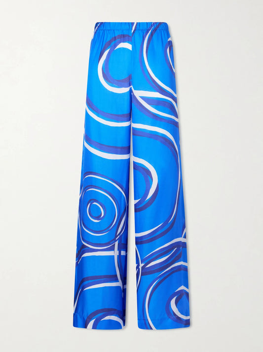 Image of a model wearing Pants. Product name - Elysia Printed Silk-blend Satin Wide-leg Pants in Blue colour by brand - Themis Z