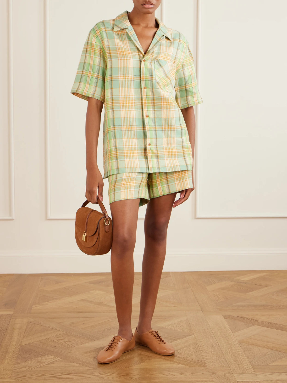 Image of a model wearing Tops. Product name - Lime Moss Checked Linen Shirt in Green colour by brand - God's True Cashmere
