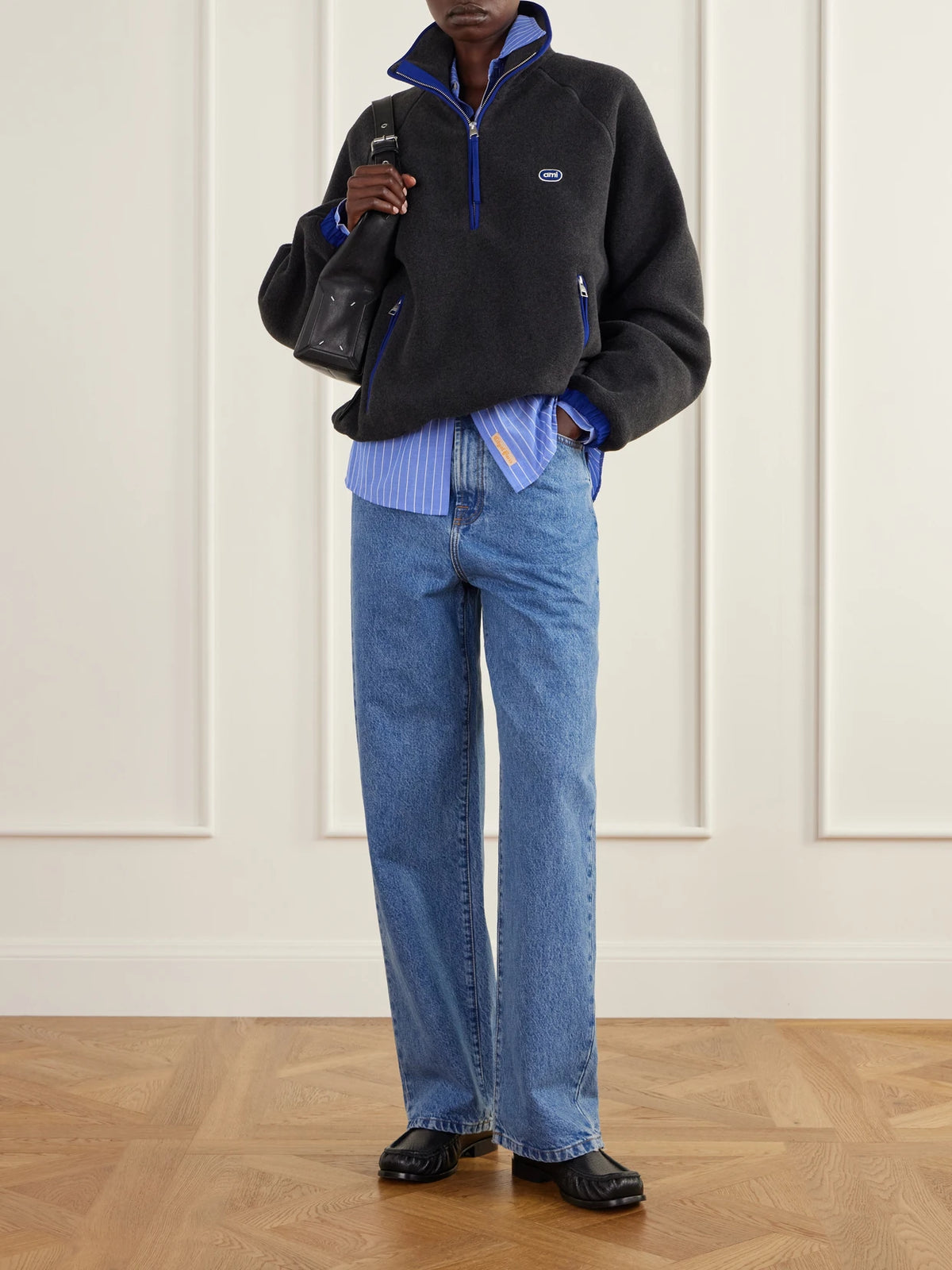 Image of a model wearing Tops. Product name - Logo-embroidered Shell-trimmed Fleece Half-zip Jacket in Dark gray colour by brand - AMI PARIS