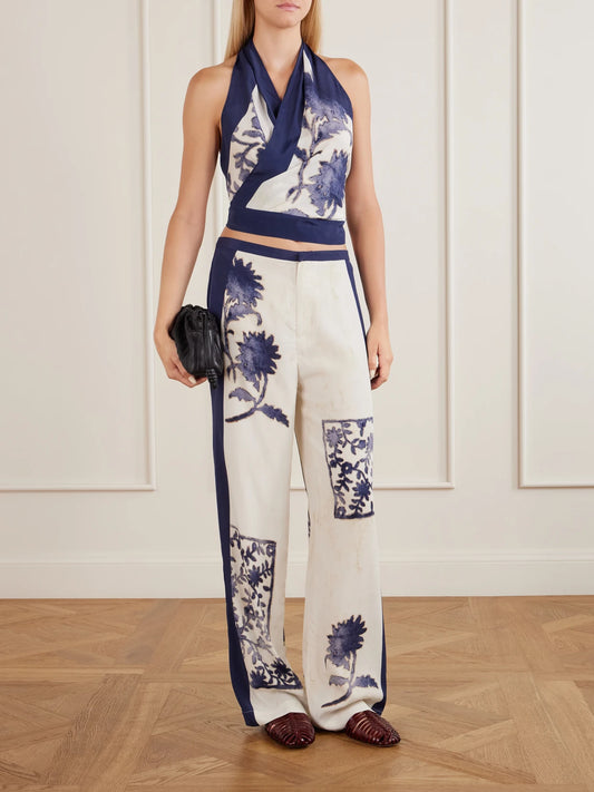 Image of a model wearing Tops. Product name - Phillipa Printed Silk-blend Halterneck Tank in Blue colour by brand - SIR.