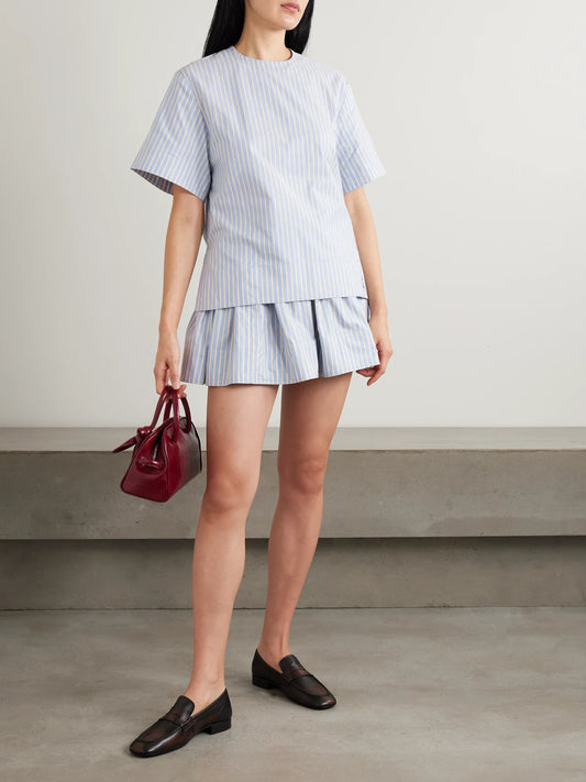Image of a model wearing Skirts. Product name - Embellished Pleated Striped Cotton-poplin Mini Skirt in Blue colour by brand - RABANNE
