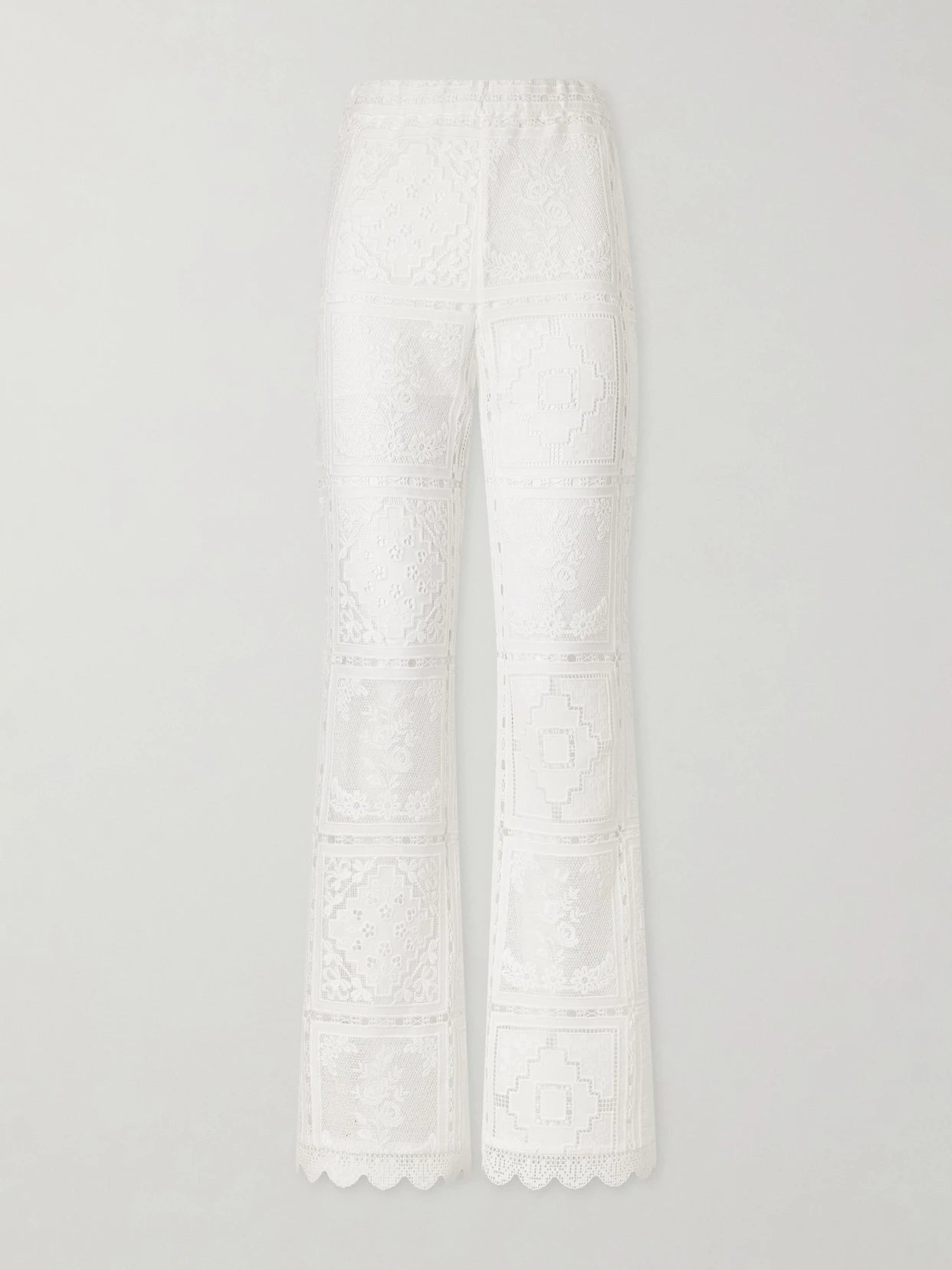 Image of a model wearing Pants. Product name - Aster Embroidered Mesh Flared Pants in Ivory colour by brand - Zimmermann