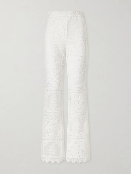 Image of a model wearing Pants. Product name - Aster Embroidered Mesh Flared Pants in Ivory colour by brand - Zimmermann