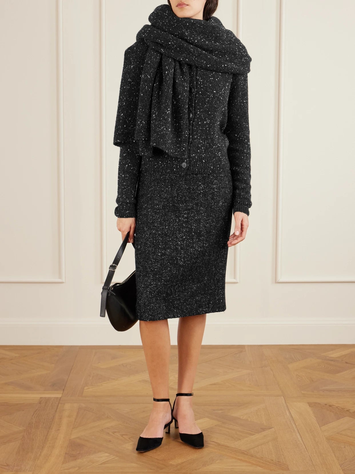 Image of a model wearing Skirts. Product name - Malva Wool Skirt in Charcoal colour by brand - The Row