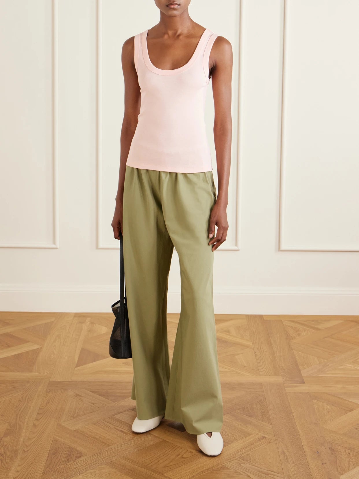 Image of a model wearing Tops. Product name - Hillie Organic Cotton-jersey Tank in Pastel pink colour by brand - FLORE FLORE