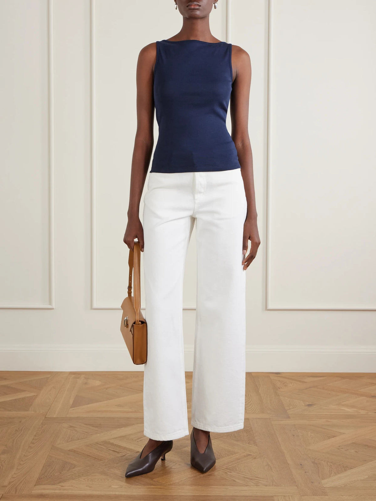 Image of a model wearing Tops. Product name - Timmi Ribbed Organic Cotton Tank in Navy colour by brand - FLORE FLORE