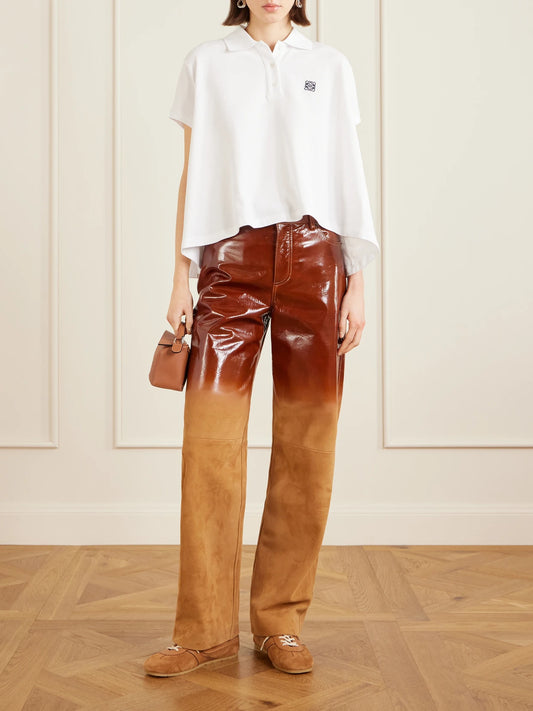 Image of a model wearing Tops. Product name - Anagram Embroidered Cotton-piqué Polo Shirt in White colour by brand - LOEWE