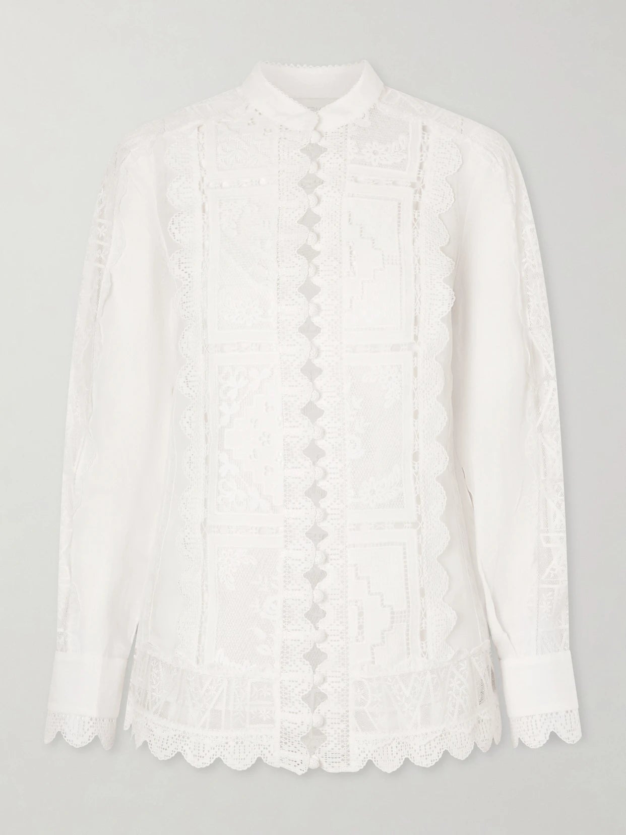 Image of a model wearing Tops. Product name - Aster Embroidered Blouse in Ivory colour by brand - Zimmermann