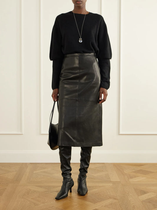 Image of a model wearing Skirts. Product name - Alana Paneled Leather Midi Skirt in Black colour by brand - Nour Hammour
