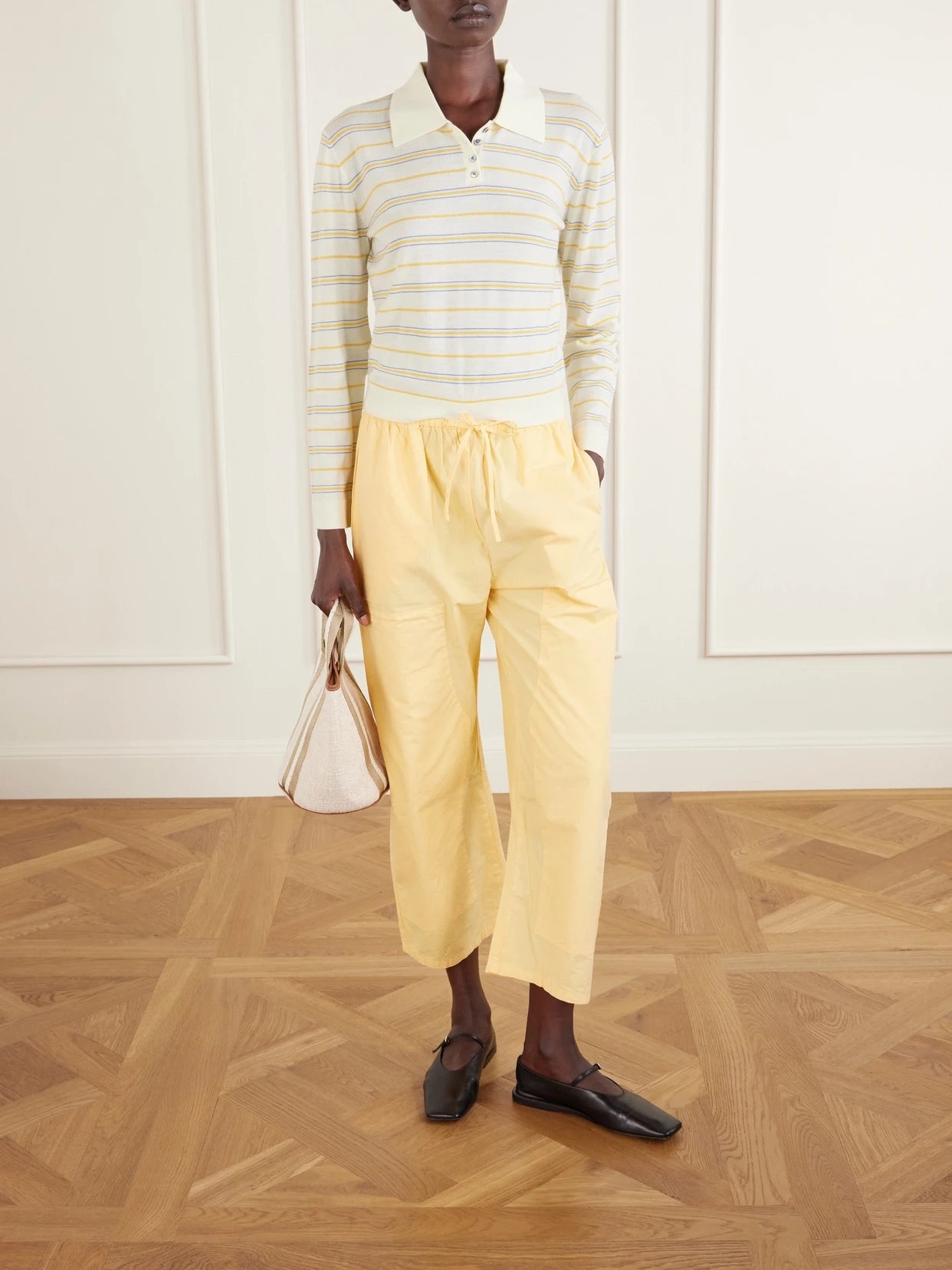 Image of a model wearing Pants. Product name - Kyoto Cotton-poplin Low-rise Wide-leg Pants in Yellow colour by brand - LESET