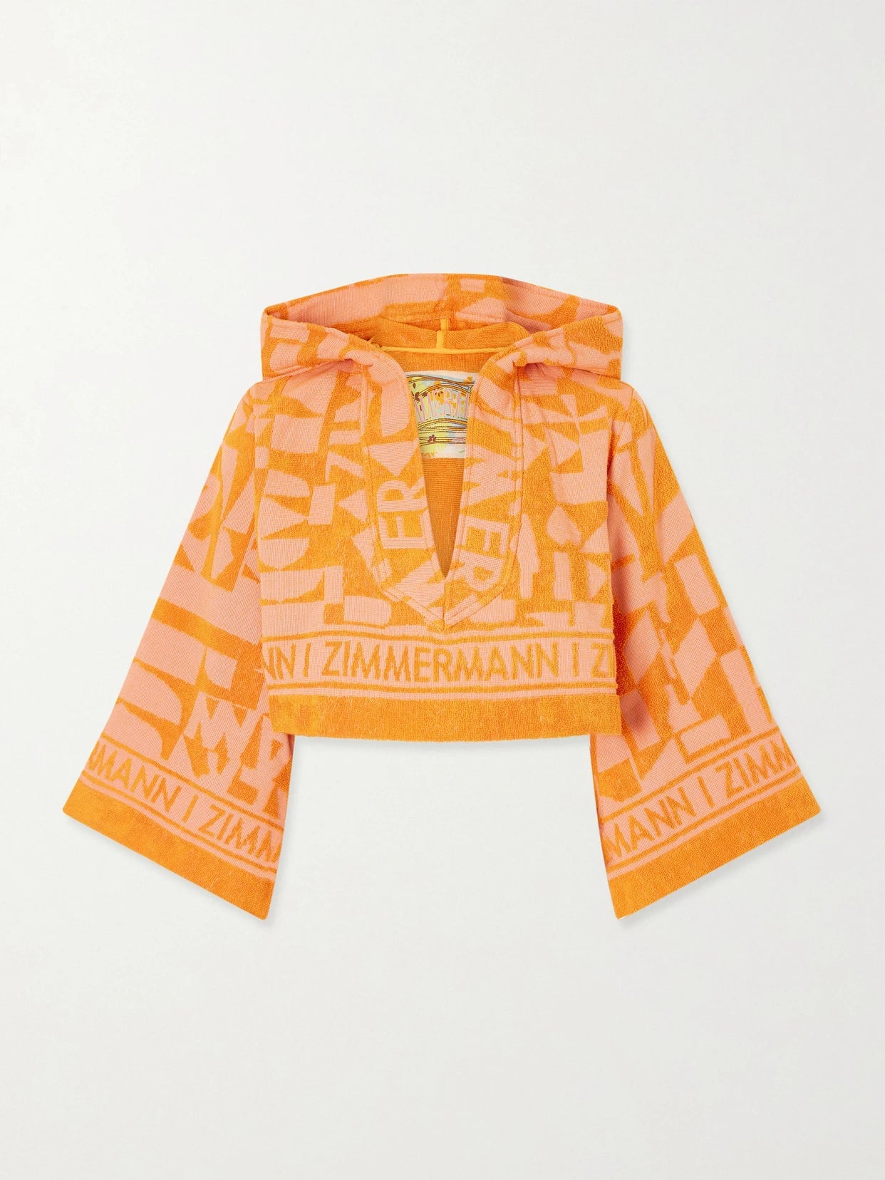 Image of a model wearing Tops. Product name - Solstice Hooded Cropped Jacquard-knit Cotton-terry Top in Orange colour by brand - Zimmermann