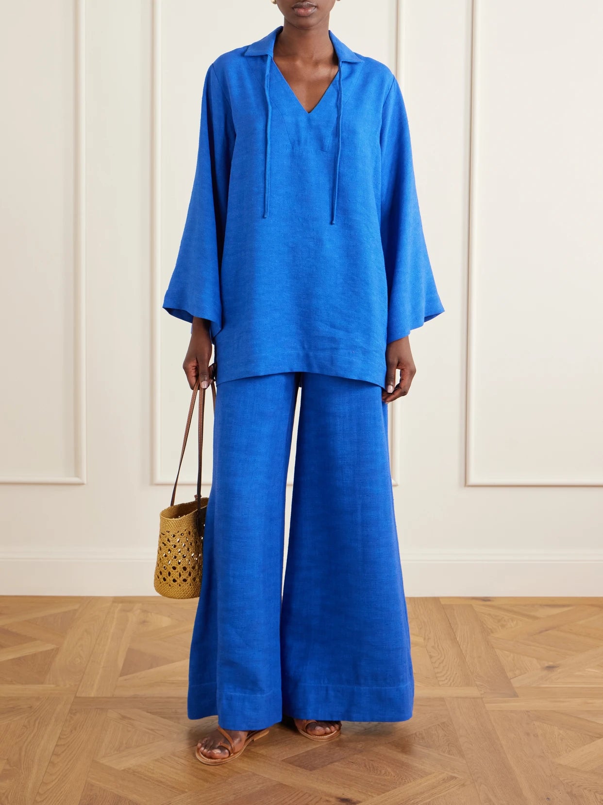 Image of a model wearing Pants. Product name - Canvas Wide-leg Pants in Blue colour by brand - Lisa Marie Fernandez