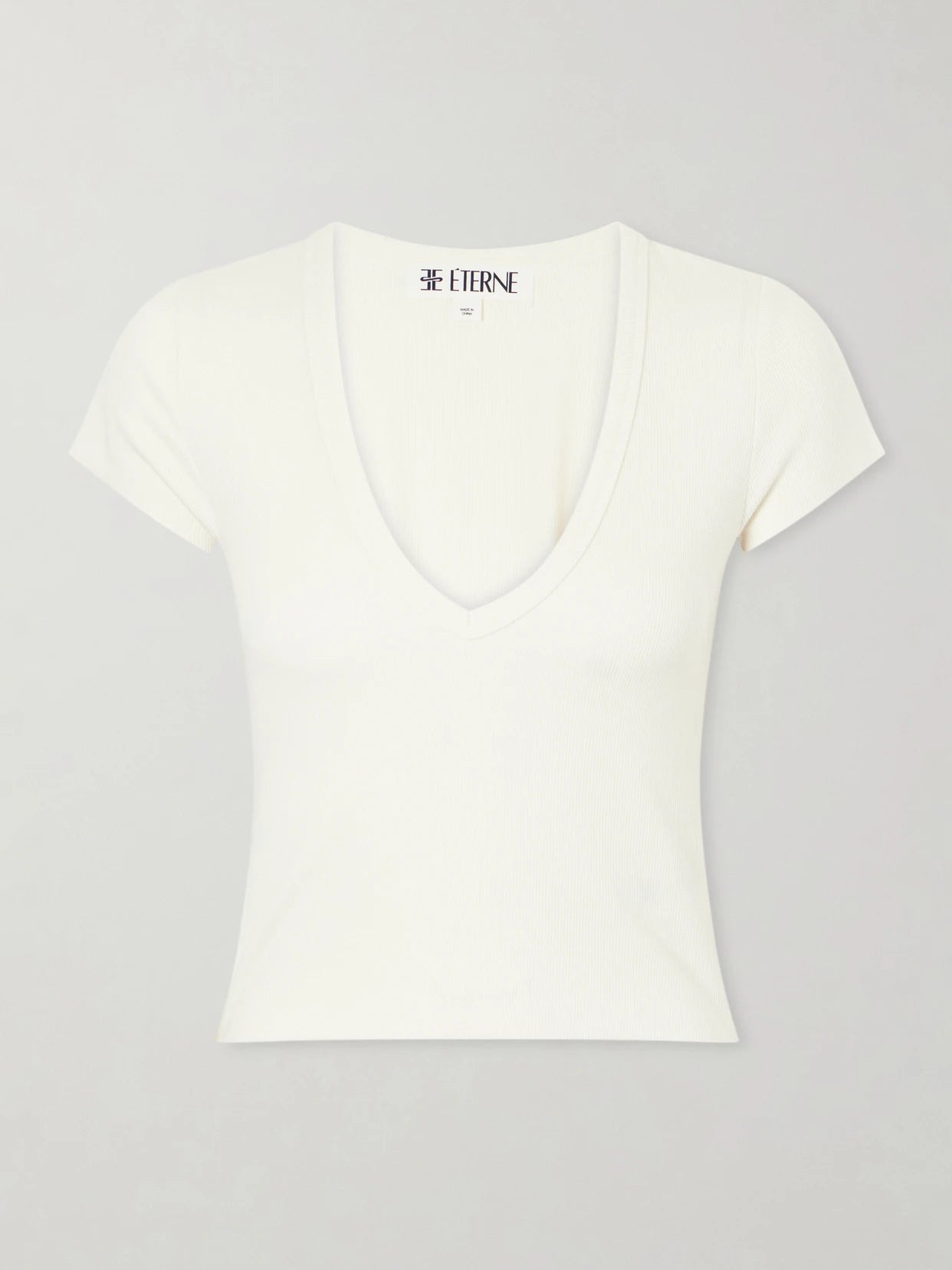 Image of a model wearing Tops. Product name - Ribbed Jersey T-shirt in Cream colour by brand - ÉTERNE