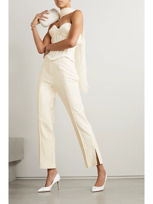 Image of a model wearing Tops. Product name - Anika Strapless Cotton-blend Twill, Tulle And Plissé-satin Bustier Top in White colour by brand - Danielle Frankel