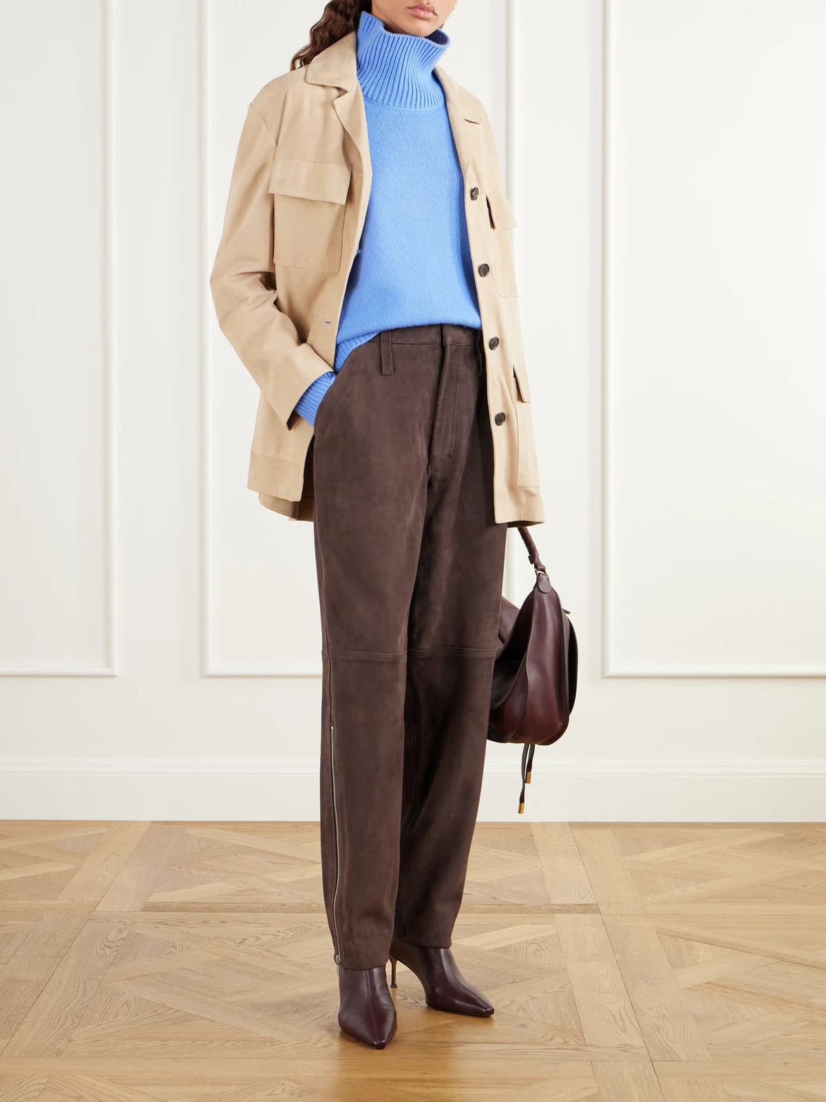Image of a model wearing Pants. Product name - Paneled Suede Tapered Pants in Chocolate colour by brand - Co