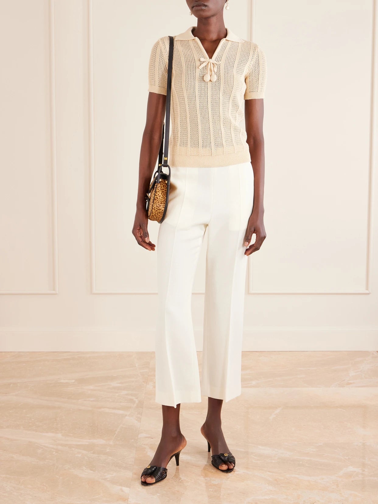 Image of a model wearing Outerwear. Product name - Pointelle-knit Cotton Polo Shirt in Cream colour by brand - Valentino Garavani