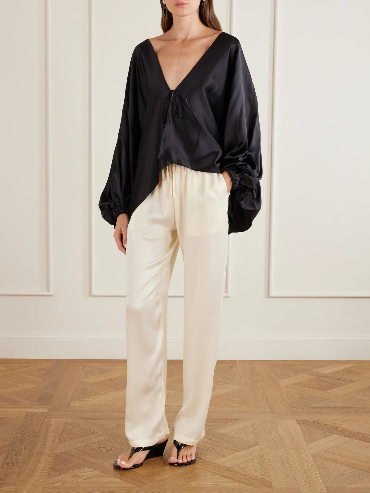 Image of a model wearing Pants. Product name - Tuileries Satin Straight-leg Pants in Ecru colour by brand - Sharon Wauchob