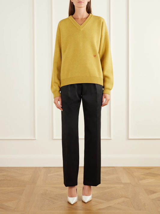 Image of a model wearing Outerwear. Product name - Chavarria Logo-embroidered Rib-trimmed Wool Sweater in Yellow colour by brand - Willy Chavarria