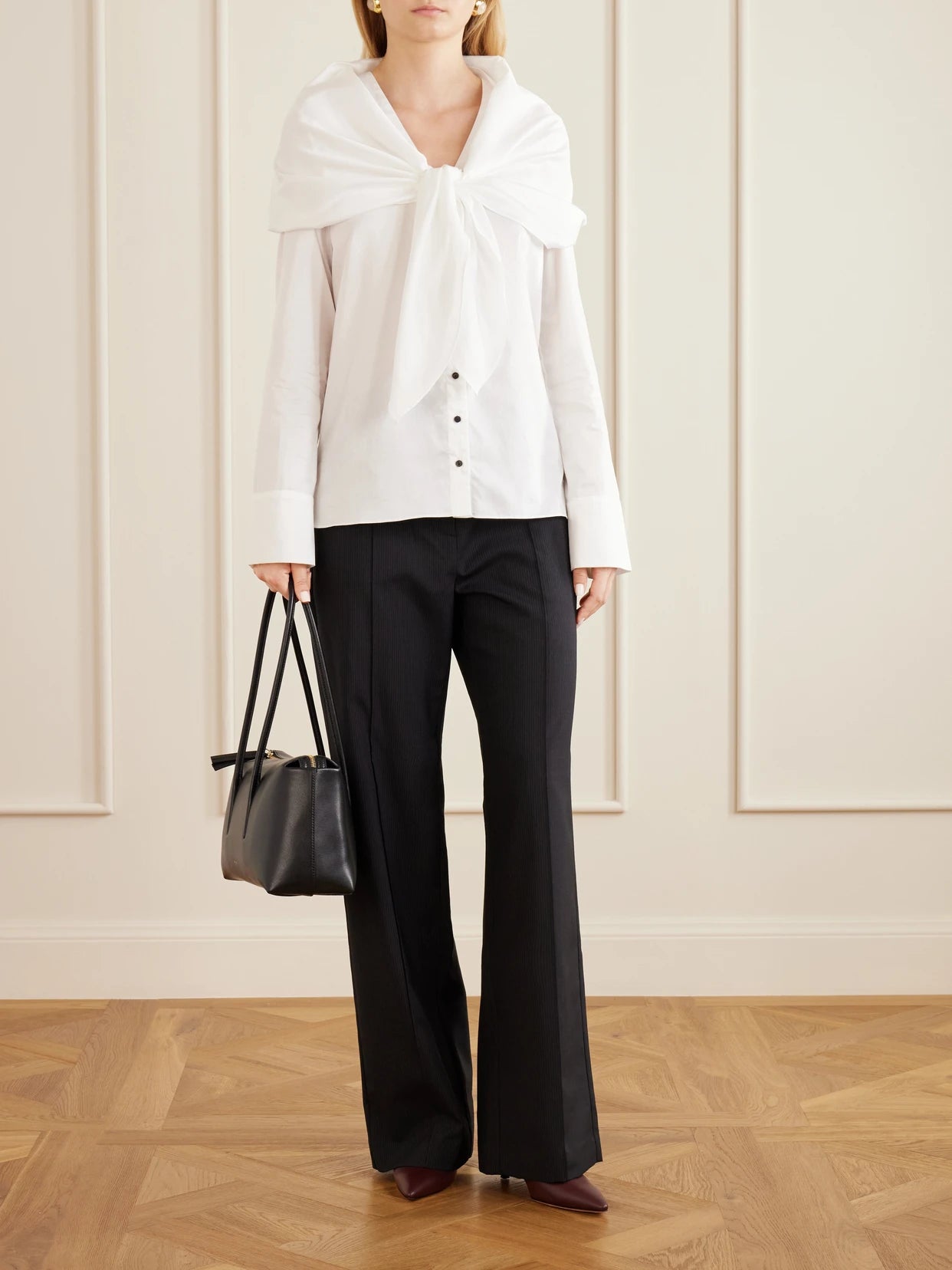 Image of a model wearing Tops. Product name - Nia Scarf-detailed Cotton-poplin Shirt in White colour by brand - TOVE