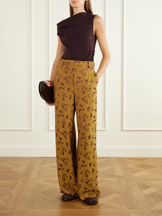 Image of a model wearing Pants. Product name - Floral-jacquard Cloqué Wide-leg Pants in Mustard colour by brand - Dries Van Noten