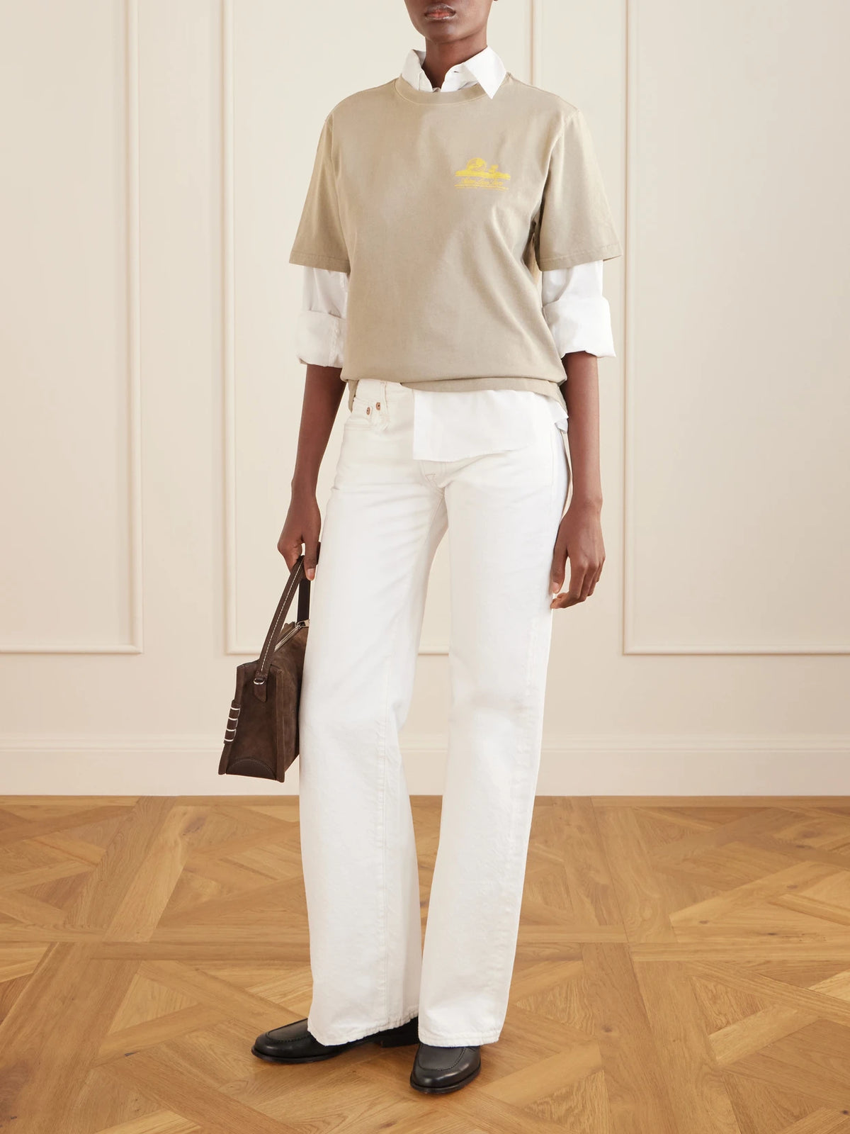 Image of a model wearing Tops. Product name - Printed Cotton T-shirt in Beige colour by brand - Aimé Leon Dore