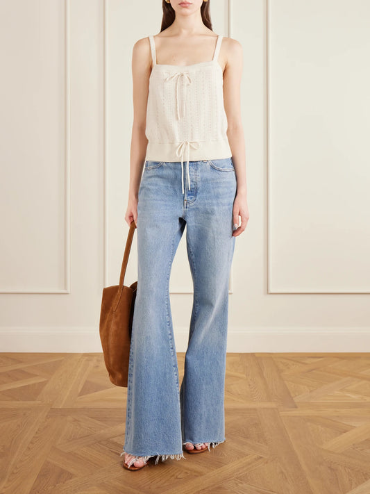 Image of a model wearing Tops. Product name - Charm Knotted Knit Cashmere Tank in Cream colour by brand - FRAME