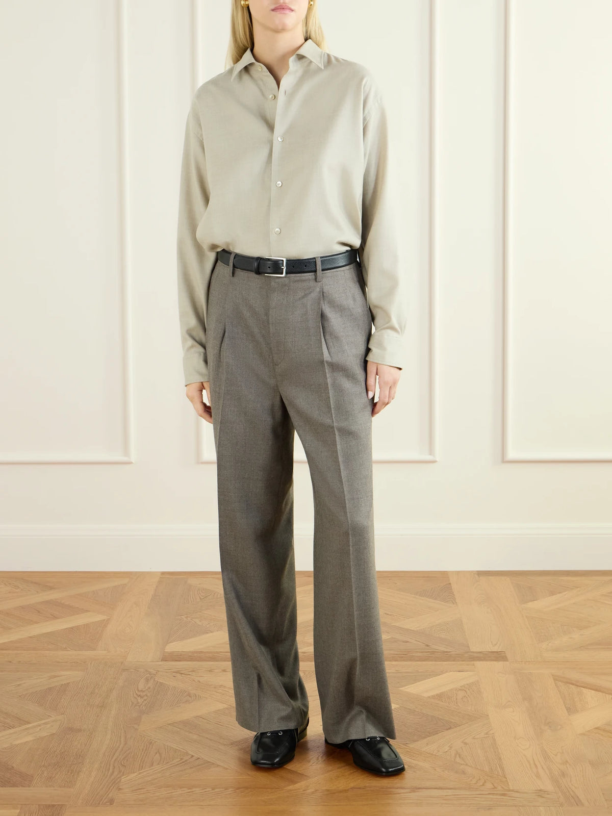 Image of a model wearing Pants. Product name - Pleated Wool Straight-leg Pants in Gray colour by brand - Auralee