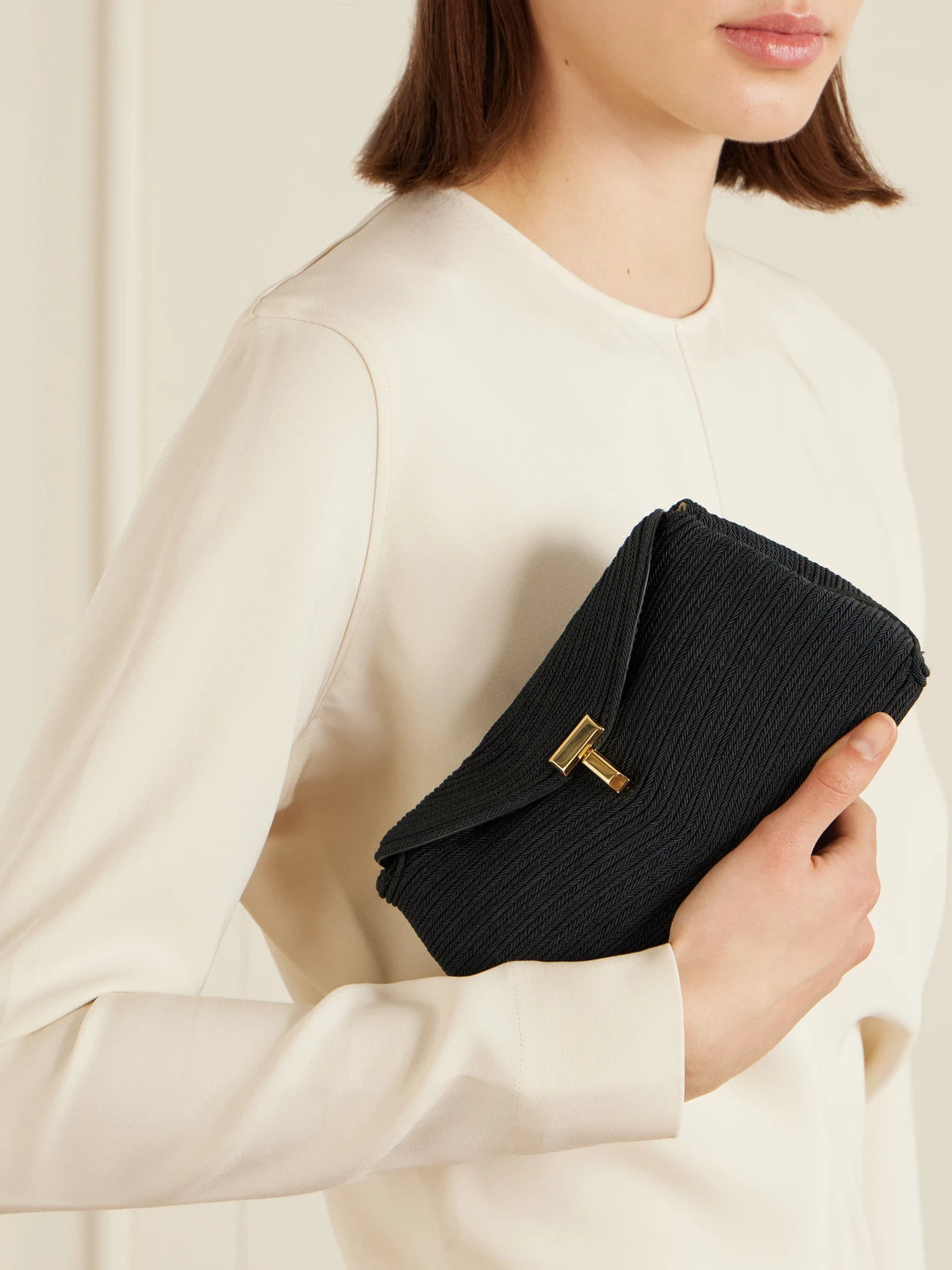 Image of Bags. Product name - Mini T-lock Leather-trimmed Woven Clutch in Black colour by brand - TOTEME