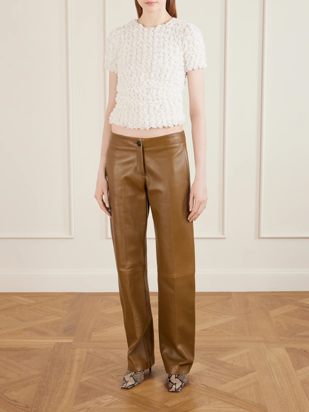 Image of a model wearing Pants. Product name - Mita Leather Straight-leg Pants in Brown colour by brand - KHAITE
