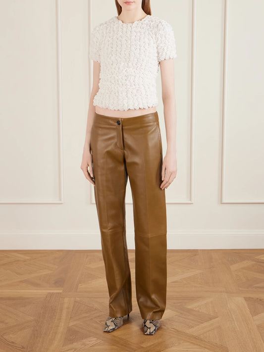Image of a model wearing Pants. Product name - Mita Leather Straight-leg Pants in Brown colour by brand - KHAITE