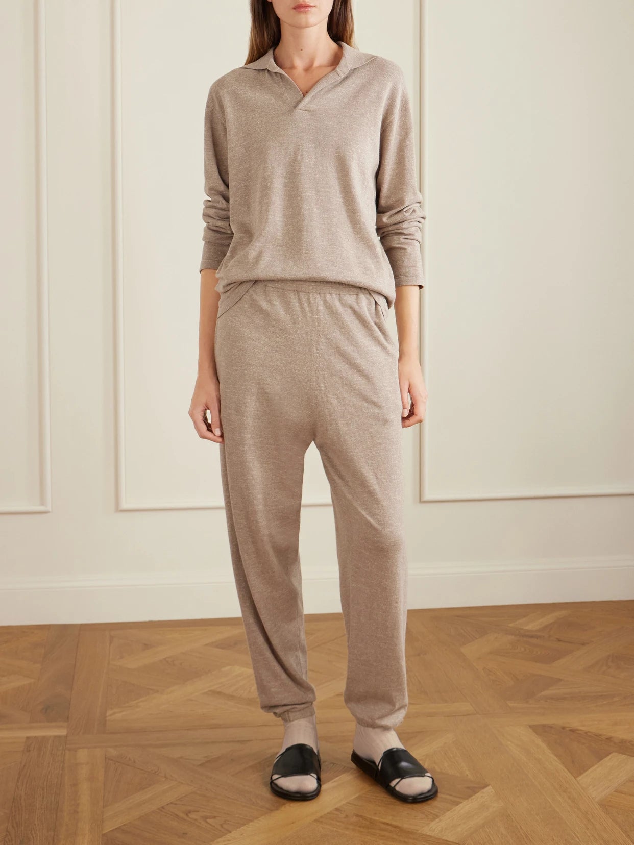 Image of a model wearing Pants. Product name - Nadir Tapered Cotton And Linen-blend Pants in Cream colour by brand - The Row