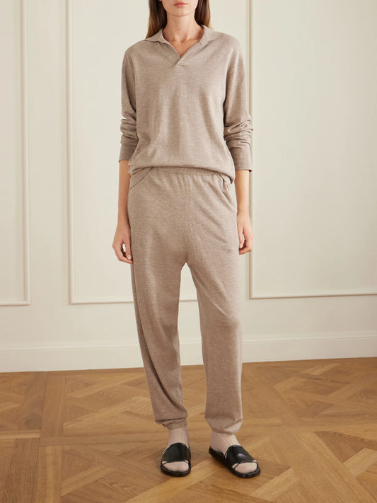 Image of a model wearing Pants. Product name - Nadir Tapered Cotton And Linen-blend Pants in Cream colour by brand - The Row