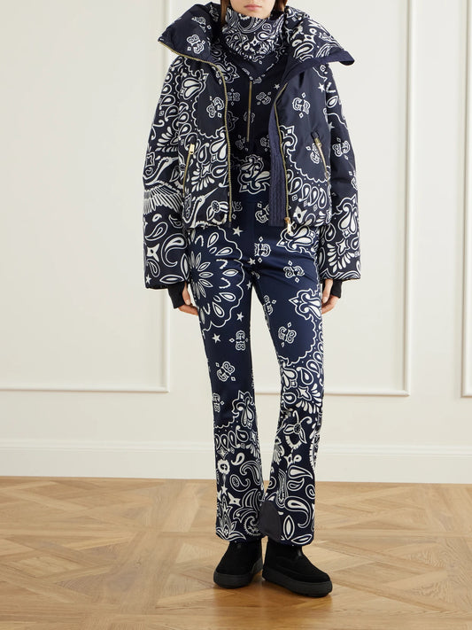 Image of a model wearing Pants. Product name - Shiro Paisley-print Shell Flared Ski Pants in Blue colour by brand - Goldbergh