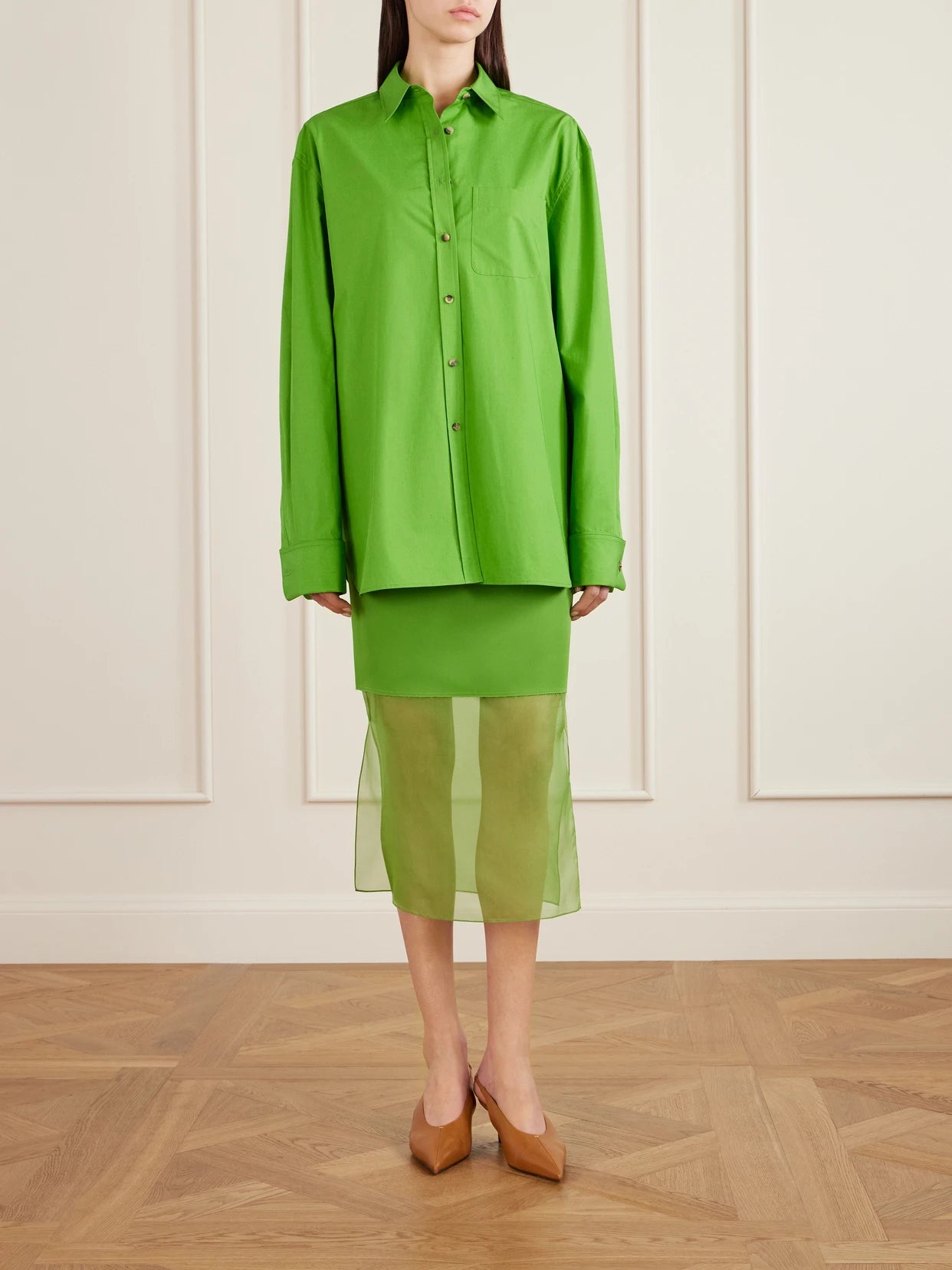Image of a model wearing Skirts. Product name - Sybil Layered Frayed Satin-crepe And Organza Midi Skirt in Bright green colour by brand - KHAITE