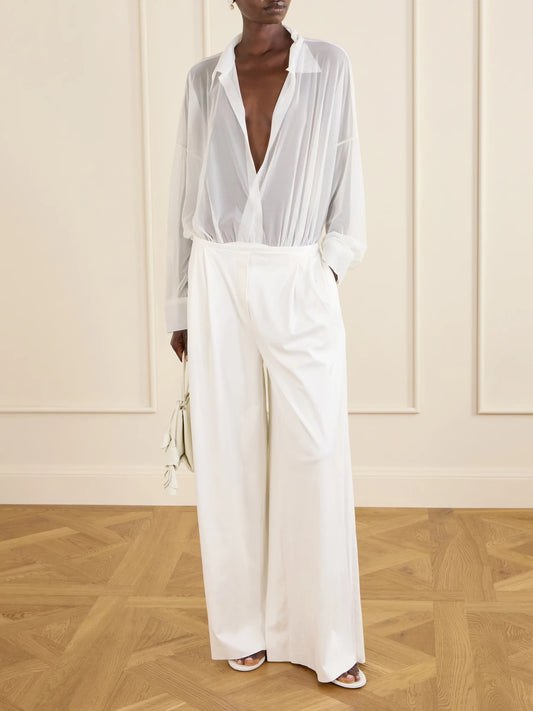 Image of a model wearing Pants. Product name - Pleated Woven Wide-leg Pants in White colour by brand - Norma Kamali