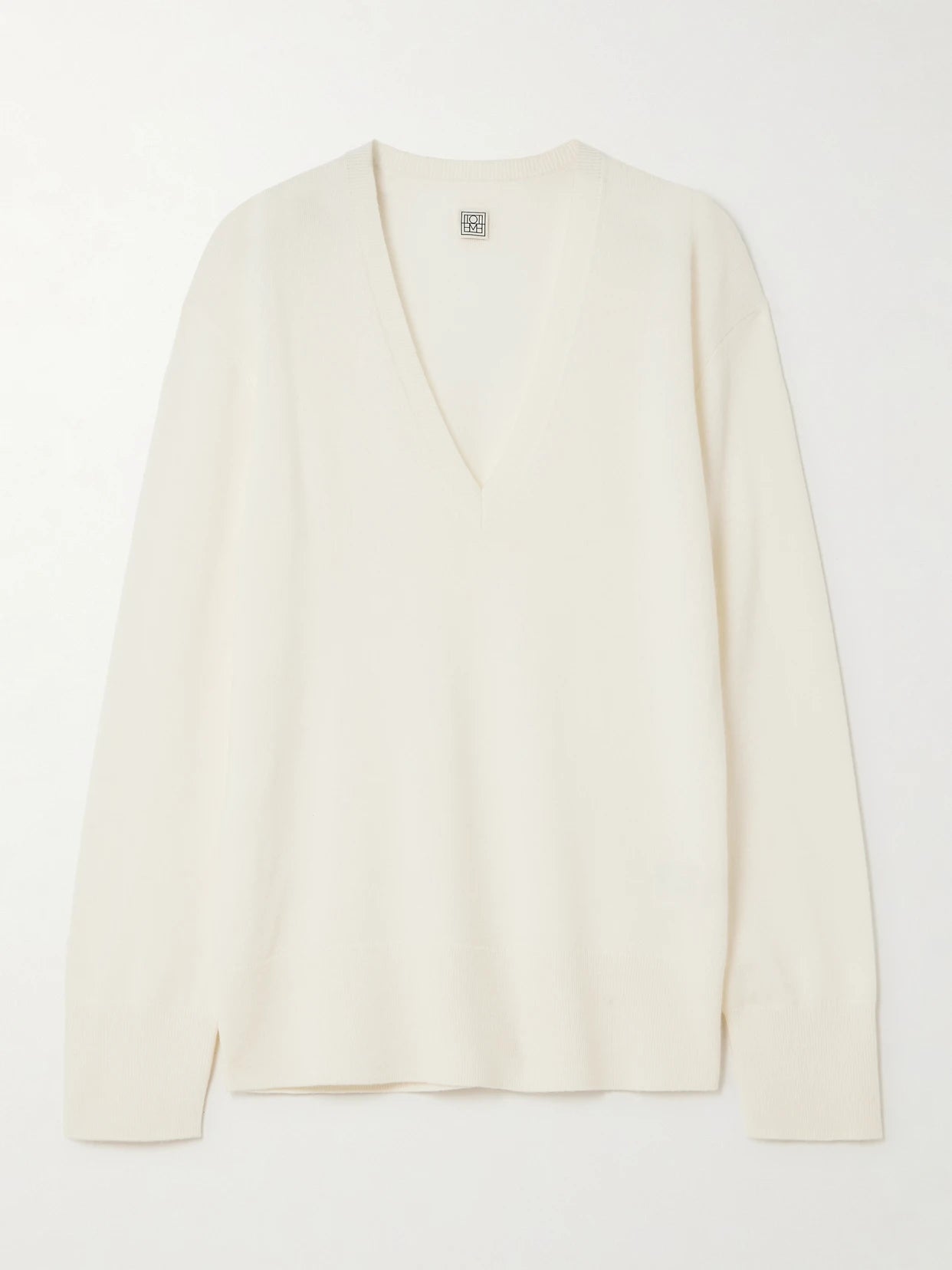 Image of a model wearing Outerwear. Product name - Garderob Cashmere Sweater in Ecru colour by brand - TOTEME