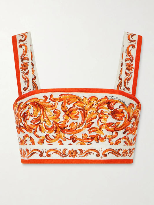 Image of a model wearing Tops. Product name - Cropped Printed Woven Top in Orange colour by brand - Dolce & Gabbana
