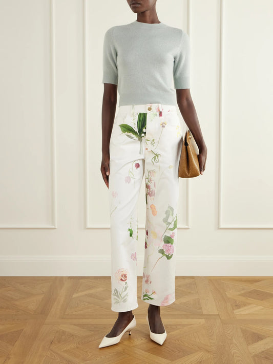 Image of a model wearing Pants. Product name - Floral-print High-rise Straight-leg Jeans in White colour by brand - Oscar de la Renta