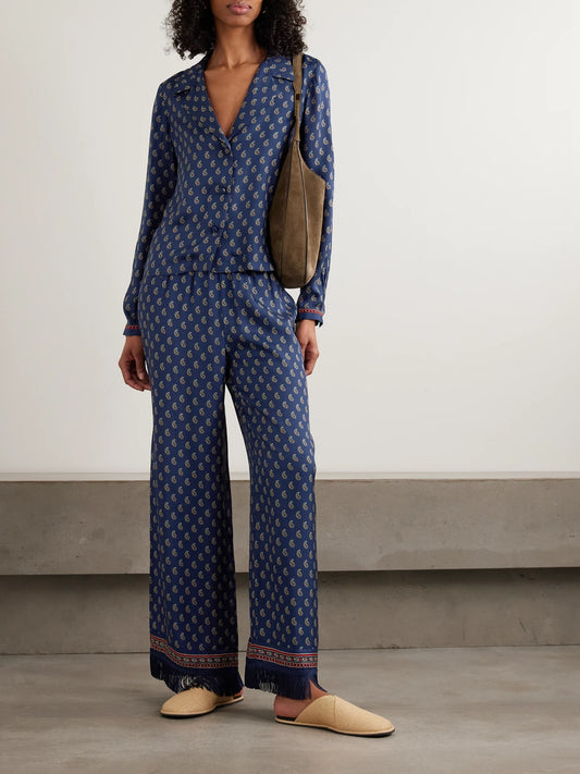 Image of a model wearing Pants. Product name - Lavon Fringed Paisley-print Silk Straight-leg Pants in Navy colour by brand - DÔEN