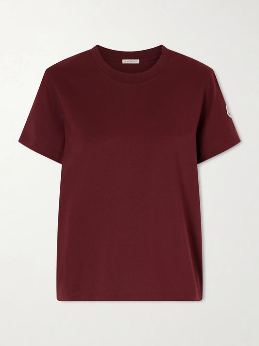 Image of a model wearing Tops. Product name - Logo-appliquéd Cotton-jersey T-shirt in Burgundy colour by brand - Moncler