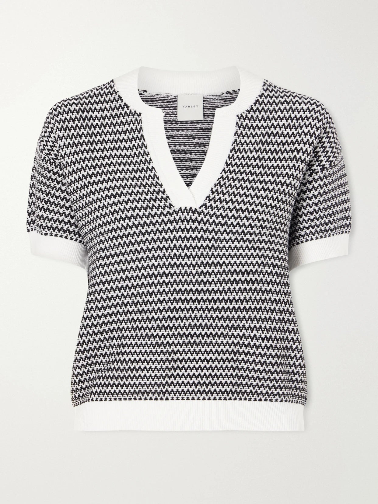 Image of a model wearing Outerwear. Product name - Dora Striped Knitted Cotton Top in Black colour by brand - Varley