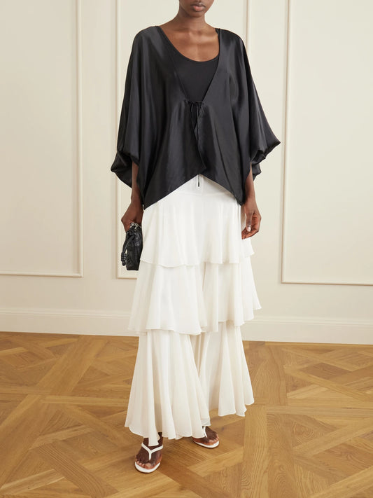 Image of a model wearing Pants. Product name - Ruffled Silk Wide-leg Pants in White colour by brand - Sharon Wauchob