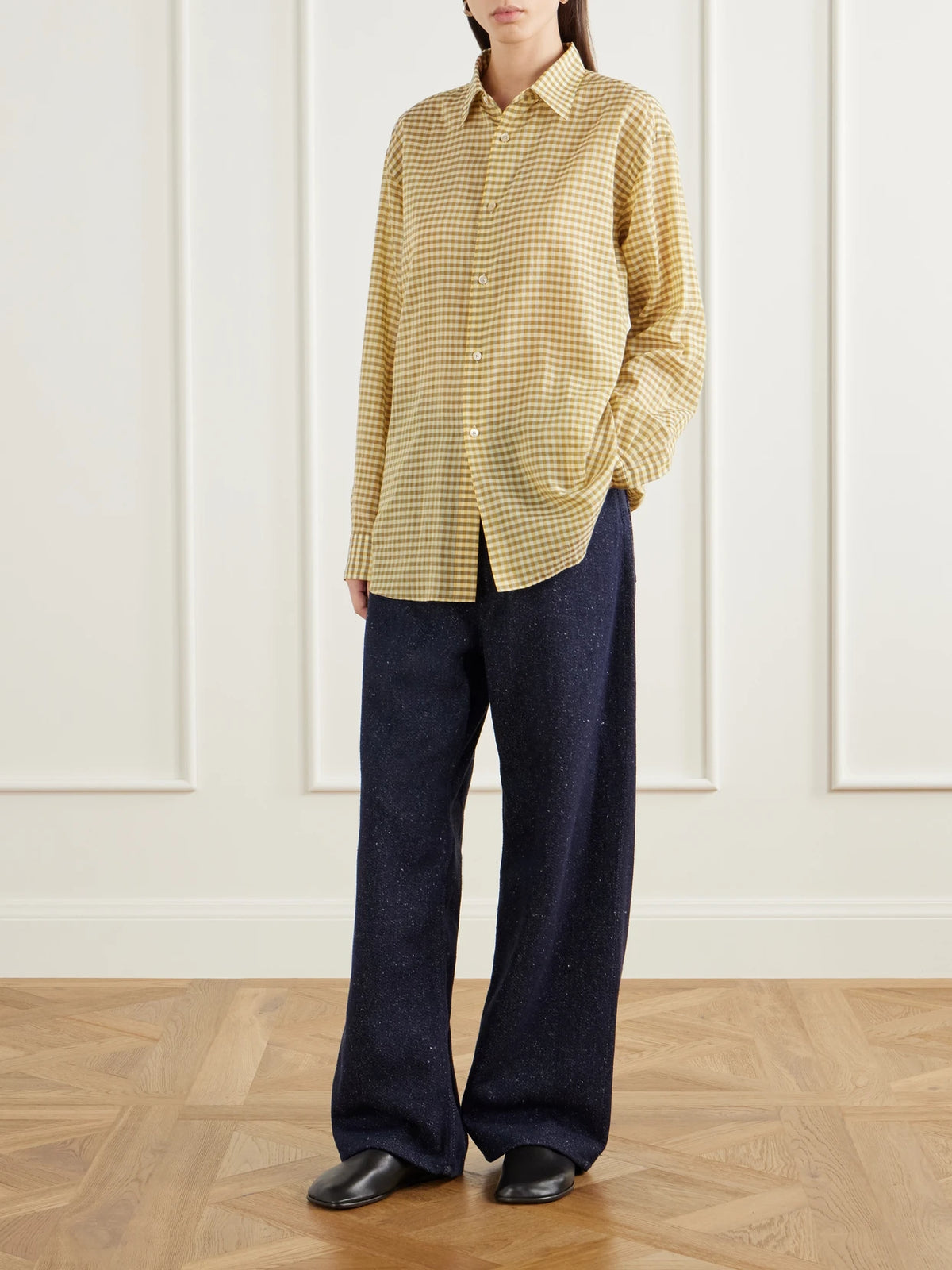 Image of a model wearing Pants. Product name - Silk Mid-rise Wide-leg Pants in Navy colour by brand - Auralee