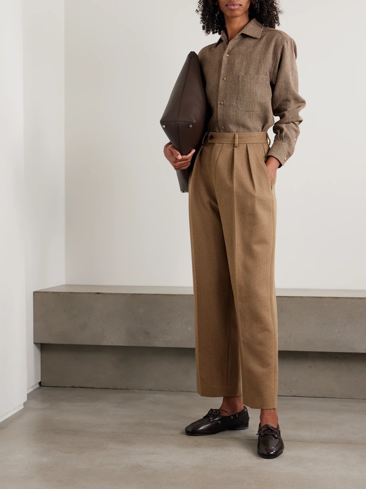 Image of a model wearing Pants. Product name - Rodger Pleated Rain System Wool-twill Tapered Pants in Brown colour by brand - Loro Piana