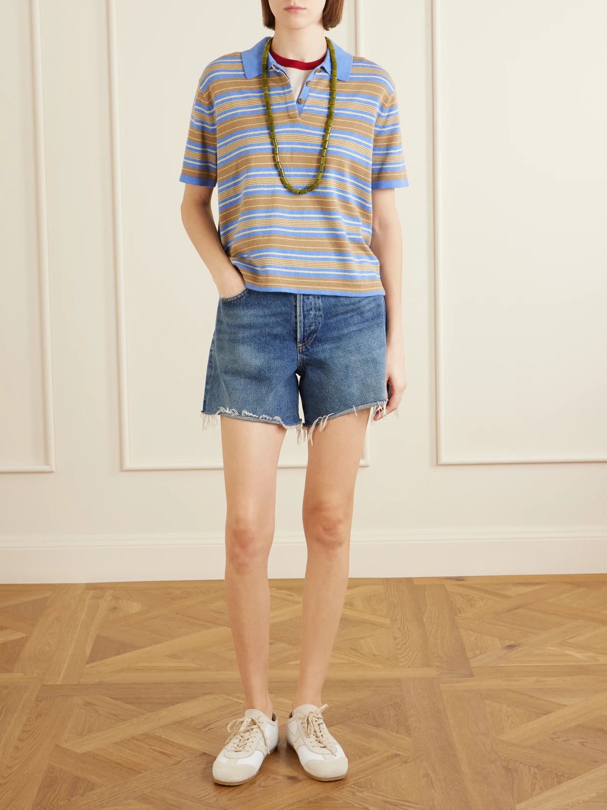 Image of a model wearing Tops. Product name - Striped Cotton And Cashmere-blend Polo T-shirt in Blue colour by brand - Guest In Residence