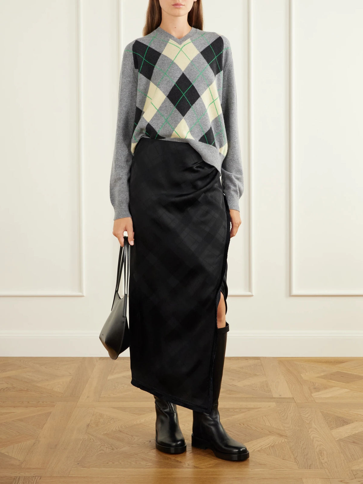 Image of a model wearing Skirts. Product name - The Alee Checked Frayed Asymmetric Satin Maxi Skirt in Black colour by brand - RÙADH